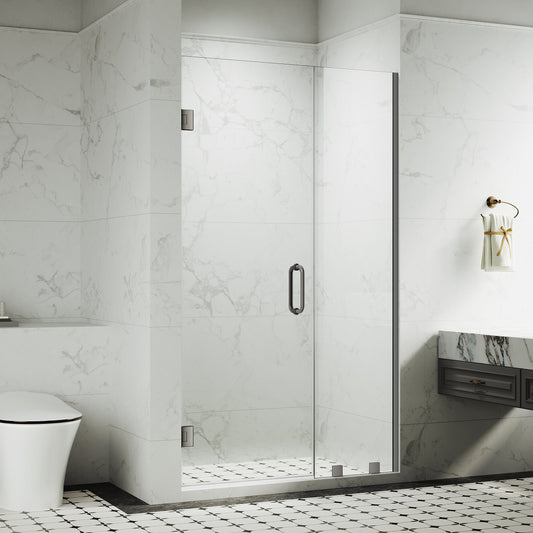 Frameless swing shower door with chrome handle and clear 10mm tempered glass installed in a modern white bathroom with subway tile and open layout