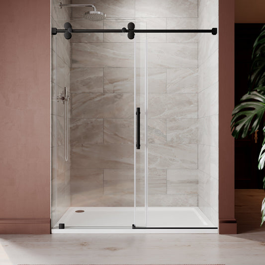 Frameless sliding shower door with matte black hardware and clear tempered glass installed in a modern bathroom with pink accent wall and large format stone tile
