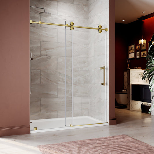 Unikoo frameless sliding shower door with brushed gold hardware and clear 10mm tempered glass installed in a luxury bathroom with warm pink accent wall